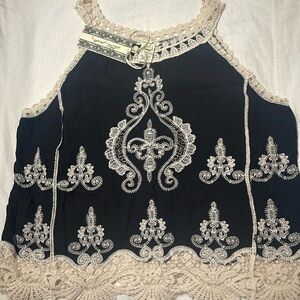 Beautiful blouse. New with tags. Size medium. Fits me big.